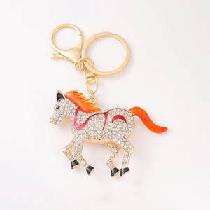 Sparkling crystal encrusted horse keychain with red enamel accents in gold finish
