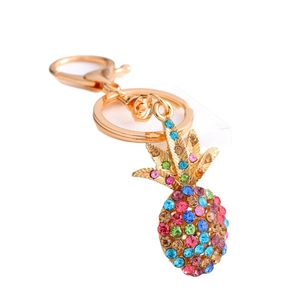 Detailed close-up of pineapple keychain with colorful rhinestones on golden alloy
