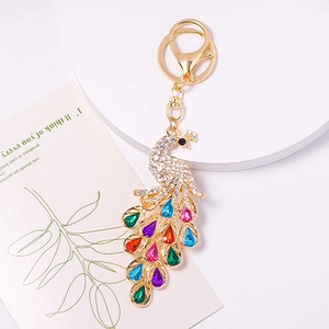 Macro shot of peacock keychain with colorful crystal gems and gold plating detail