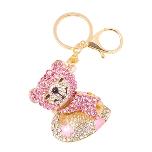 Portachiavi orsetto con strass rosa brillanti e base floreale in finitura dorata