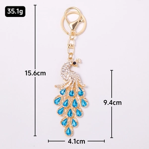 Colorful crystal peacock keychain with blue rhinestones and gold metal finish details