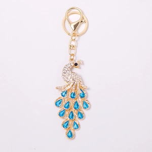 Exquisite gold metal peacock keychain with blue teardrop crystals and white rhinestones