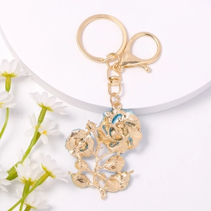 Elegant gold rose keychain with light blue enamel petals and sparkling crystal accents