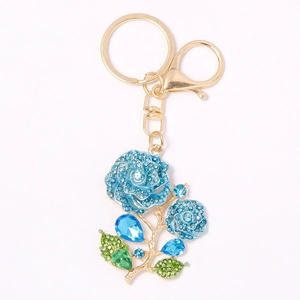 Elegant gold metal keychain featuring blue rose charms with sparkling blue and green rhinestones