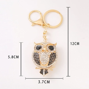 Detailed view of owl keychain with white rhinestones and size markings 12cm by 5.8cm