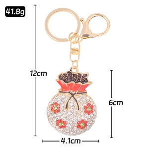 Lucky money bag keychain with red and white crystals and golden metal finish