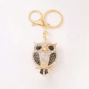 Exquisite golden owl keychain with sparkling white rhinestones and black enamel wings