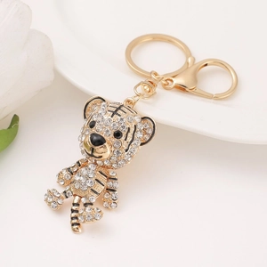 Golden zodiac tiger keychain with white crystals and lobster clasp on white background
