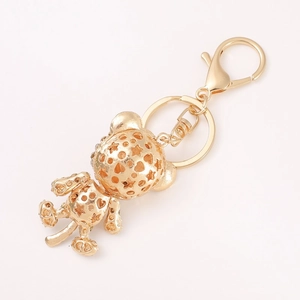Hollow gold bear keychain with star and heart patterns and lobster clasp closure