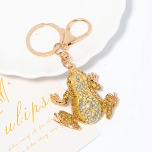 Macro detail of frog keychain with colorful rhinestones and golden hardware
