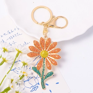 Detailed macro view of sparkling rhinestone sunflower keychain in a bright setting