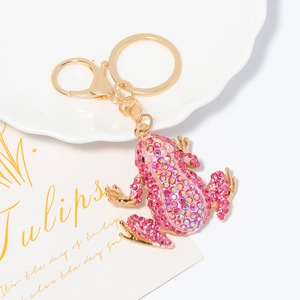 Detailed macro view of pink rhinestone-encrusted frog keychain with gold lobster clasp