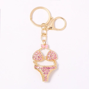Sparkling pink rhinestone bikini keychain with golden finish and pink bow detail