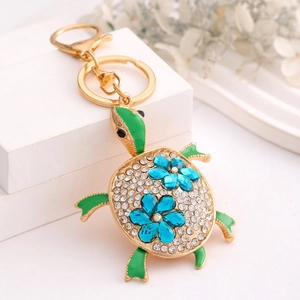 Exquisite turtle keychain with green enamel and sparkling crystals on a gold metal base