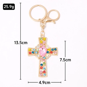 Cross keychain with colorful crystals and pink heart stone on a gold metal chain