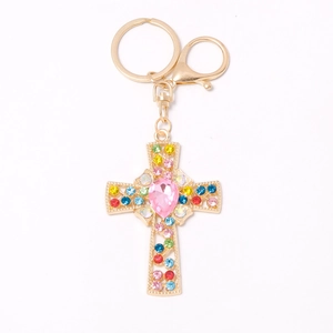 Colorful cross keychain with pink rhinestone center and gold metal plating for holidays
