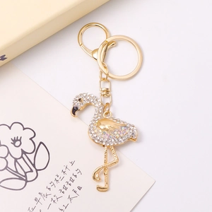 Detailed close-up of golden flamingo keychain with sparkling crystals and lobster clasp