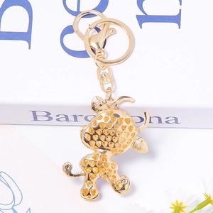 Luxury rhinestone golden ox keychain with heart pattern cutout and lobster clasp detail