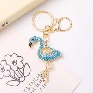Detail of flamingo keychain with light blue rhinestones on a gold alloy base
