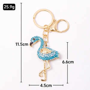 Sparkling pink flamingo keychain with blue rhinestones and gold-plated metal clasp
