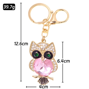Sparkling owl keychain with pink gemstone, crystal rhinestones, and gold-plated metal