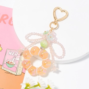 Detail of colorful crystal beaded keychain with heart clasp and floral bow decoration