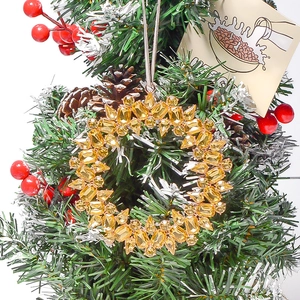 Close-up of amber crystal Christmas tree ornament hanging on festive green branches