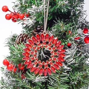 Close-up of golden Christmas wreath pendant with double-layered red marquise rhinestones