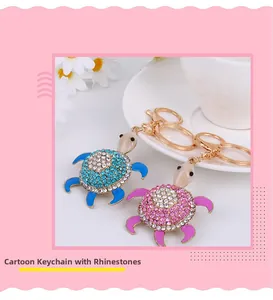Detail of pink and blue rhinestone turtle keychains with gold hardware and gemstone heads