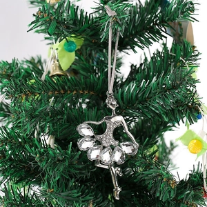 Detailed close-up of a silver ballerina ornament with crystals on a Christmas tree