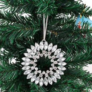 Crystal snowflake ornament with silver metal base and silk ribbon on Christmas tree