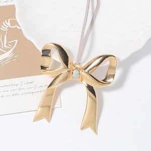 Ornement de Noël en forme de nœud doré avec strass scintillant et cordon de suspension