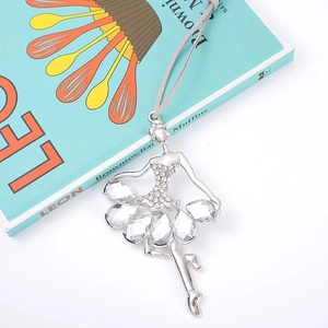 Sparkling ballerina dancer ornament with teardrop rhinestones on a decorative book