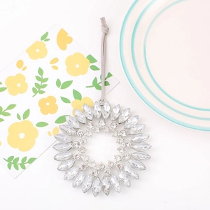 Close-up of sparkling sunflower crystal pendant with intricate rhinestone petal detailing