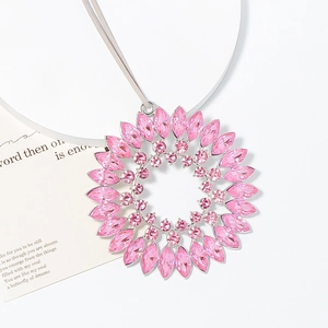 Macro shot of large pink sunburst crystal pendant with marquise stones and silver alloy base