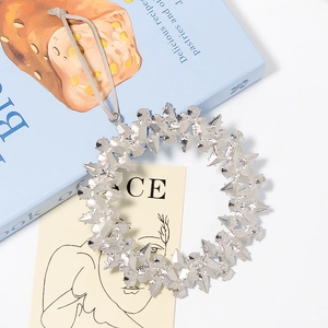 Silver Christmas tree wreath pendant with crystal star texture on blue books