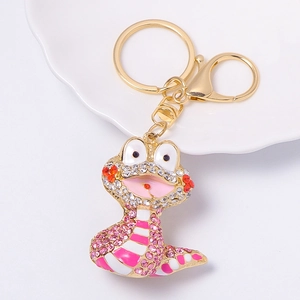 Detailed view of cartoon snake keychain with pink enamel and sparkling rhinestones