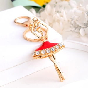 Elegant gold ballerina keychain with red enamel dress and sparkling rhinestones