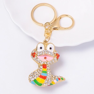 Detailed macro view of a gold-tone snake keychain with rainbow rhinestones and crystal accents
