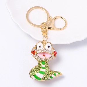 Detail of cartoon snake keychain with gold plating and colorful rhinestones