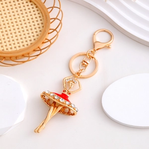 Detailed view of ballet girl keychain with red enamel dress and sparkling rhinestones