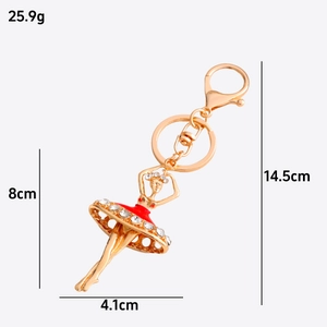 Golden ballerina keychain with red rhinestone dress including precise size and weight specs