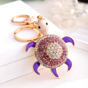 Exquisite gold-plated turtle keychain with purple rhinestones and enamel on white display