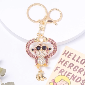 Macro shot of gold rhinestone gorilla keychain with pink crystal heart and banana charm