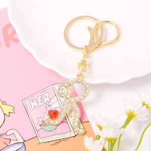 Sparkling crystal letter R keychain with red heart gemstone and gold lobster clasp detail