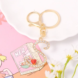 Detail of crystal letter S keychain with sparkling rhinestones and a small red heart charm