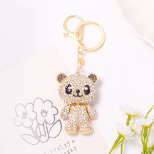 Macro shot of gold panda keychain with sparkling rhinestones on a decorative card