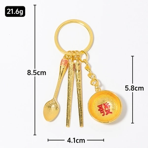 Golden tableware keychain with spoon and chopsticks, engraved lucky bowl on white background