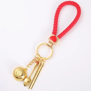 Golden bowl spoon and chopsticks keychain with red braided lanyard and Fu symbol