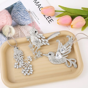 Zinc alloy Christmas bird ornaments with rhinestones on a decorative display tray